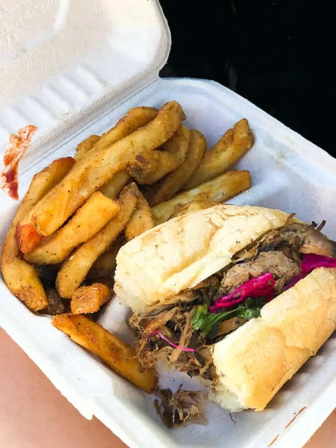 A chicken sandwich and fries on a plate.