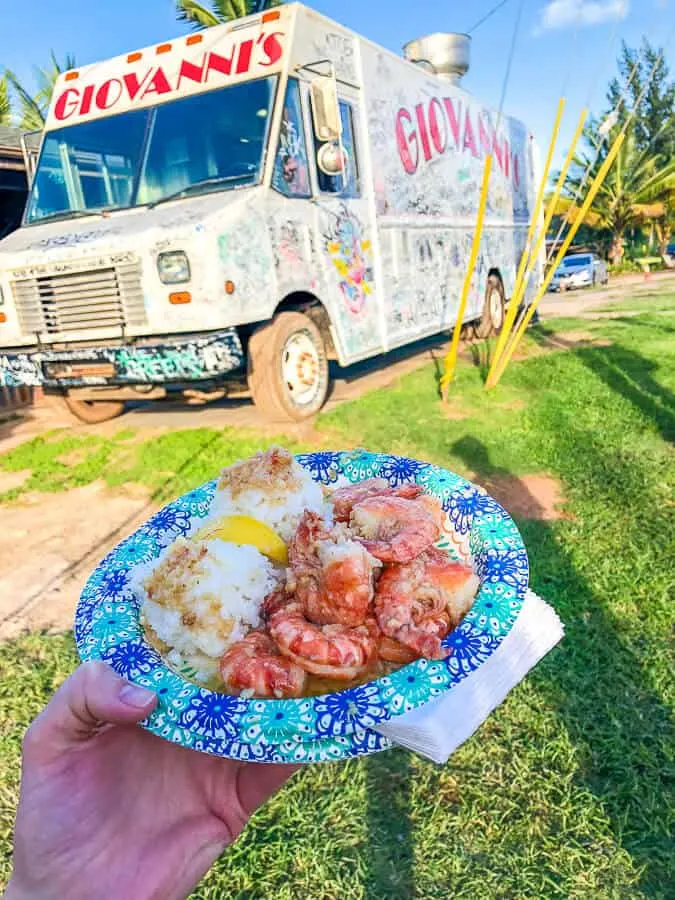 Woman holds food from food truck in Hawaii.