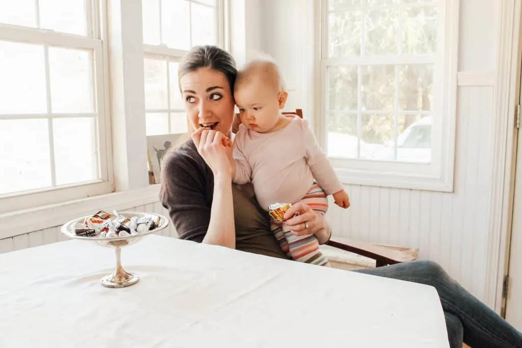 First time mom and baby sit in dining room.