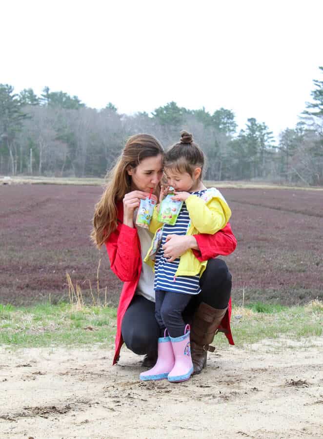 Mom and Girl with Ocean Spray Growing Goodness Juice drink at cranberry bog