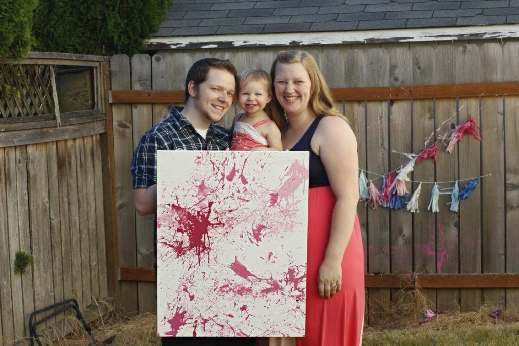 Pink paint on a white canvas for a baby gender reveal.