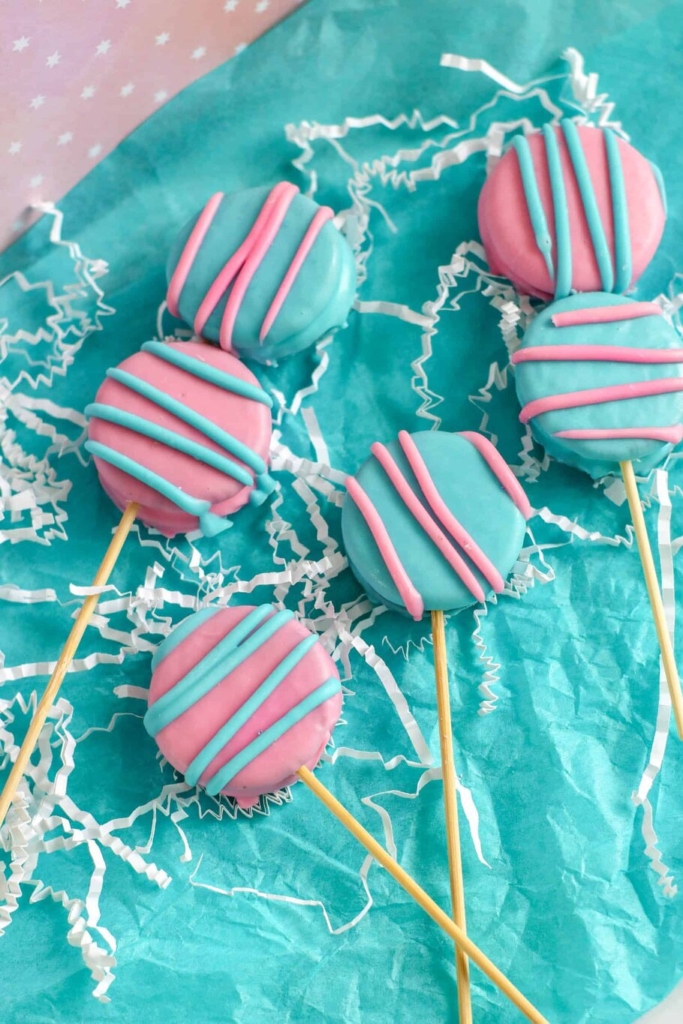 Oreo pops with pink and blue icing.