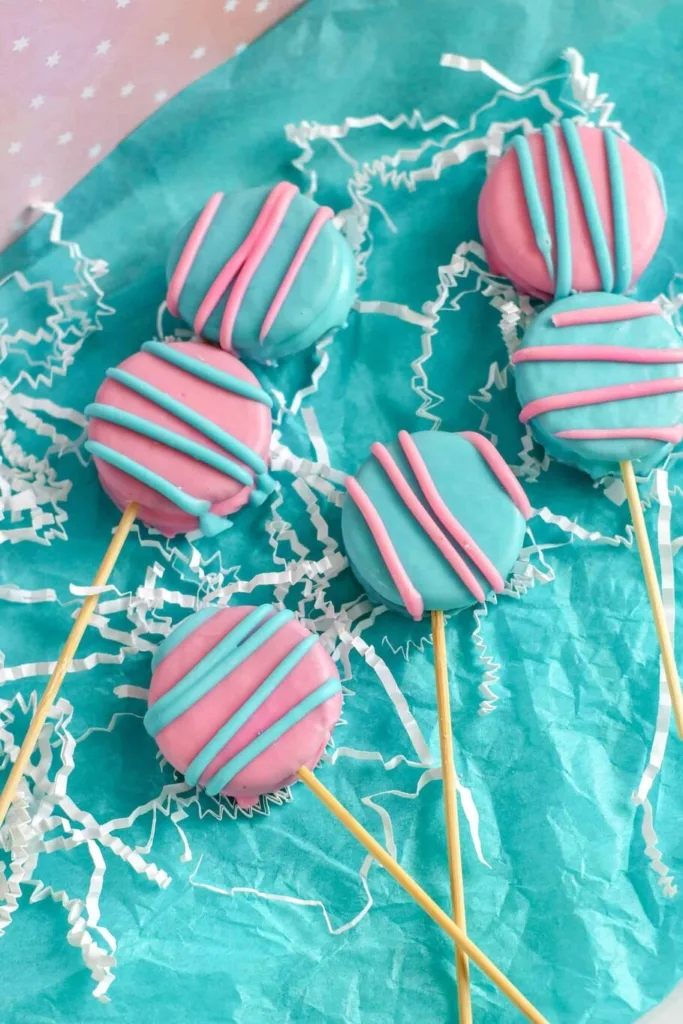 Oreo pops with pink and blue icing.