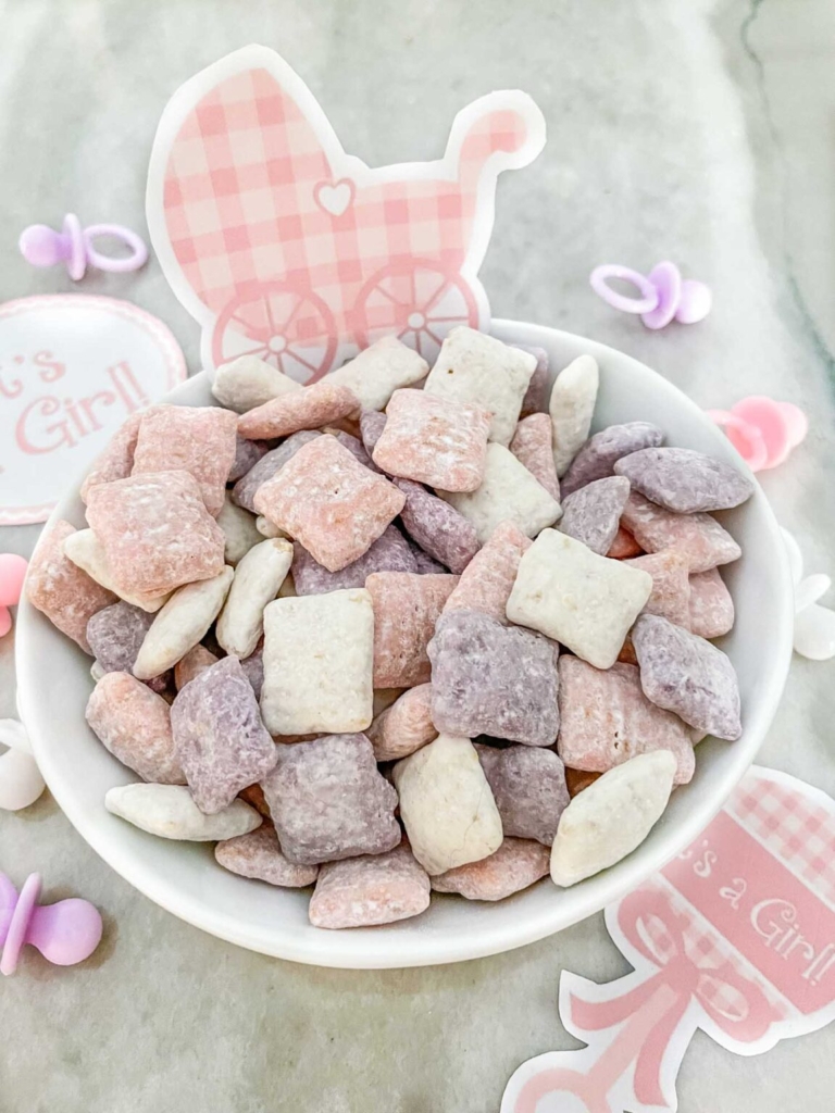Pink and white gender reveal puppy chow party snack.