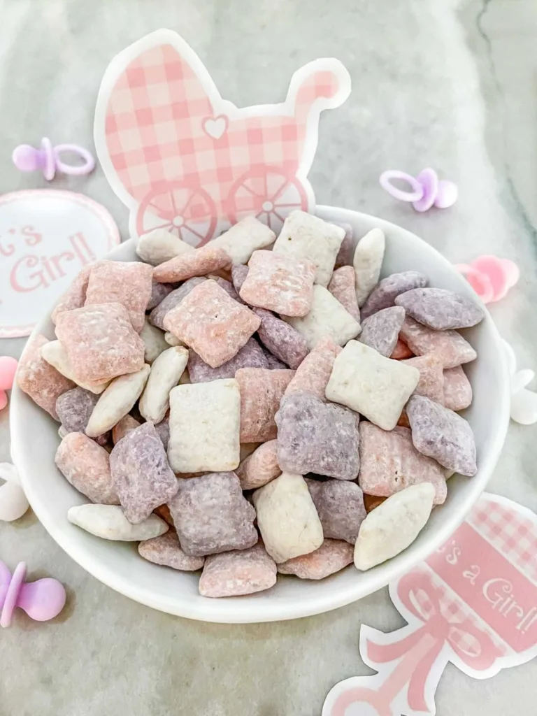 Pink and white gender reveal puppy chow party snack.