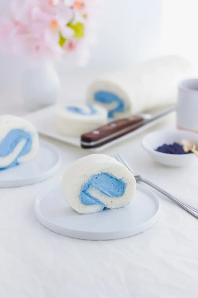 White and blue cake roll cake with blue in the center.