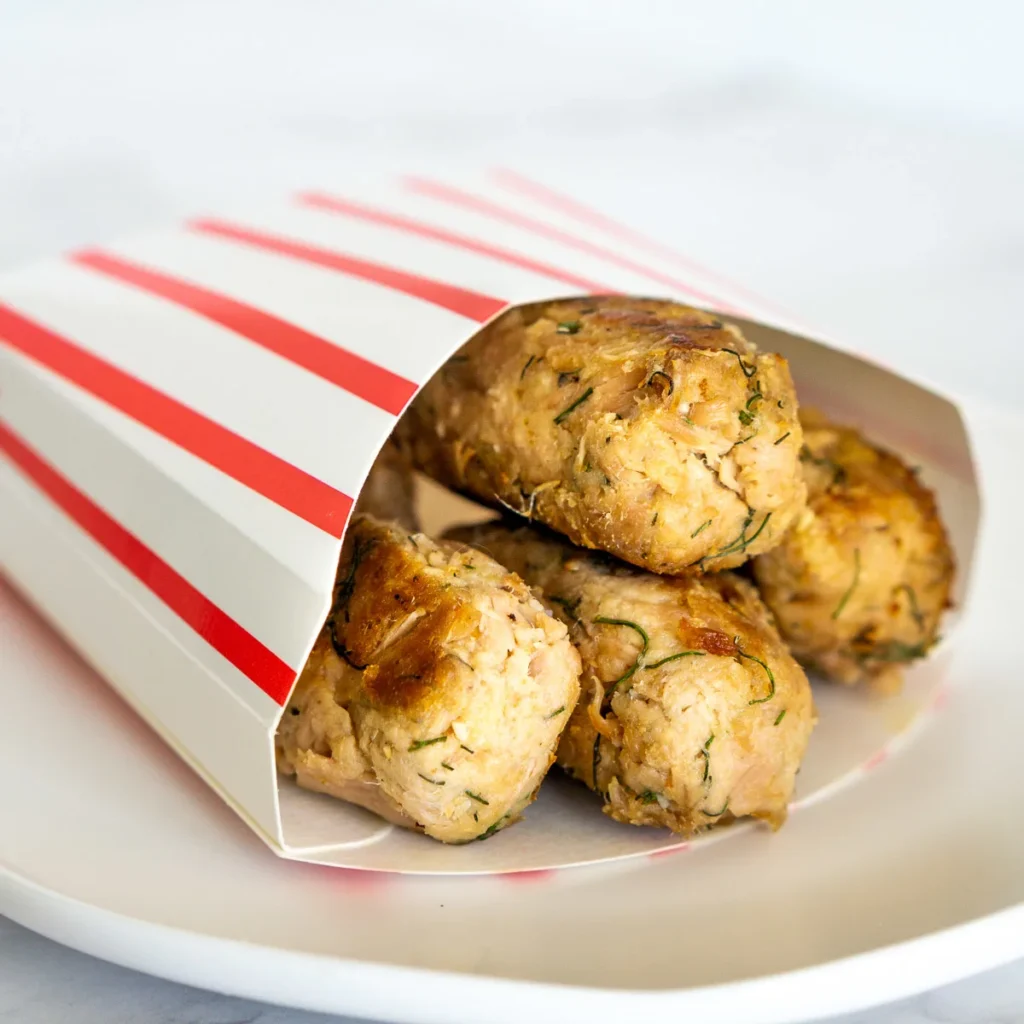 Tuna nuggets in a red and white striped cardboard container.