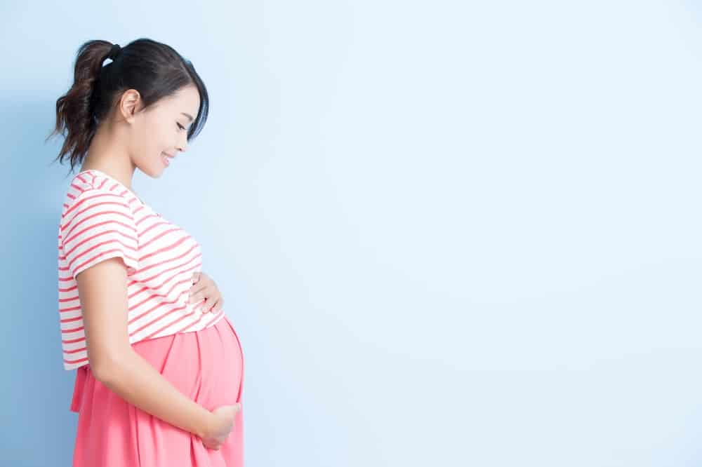 Pregnant woman on blue background