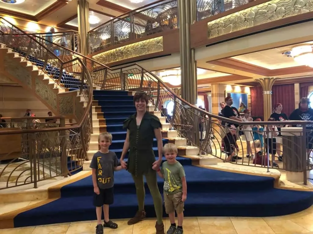Peter Pan with boys on Disney Dream in front of staircase