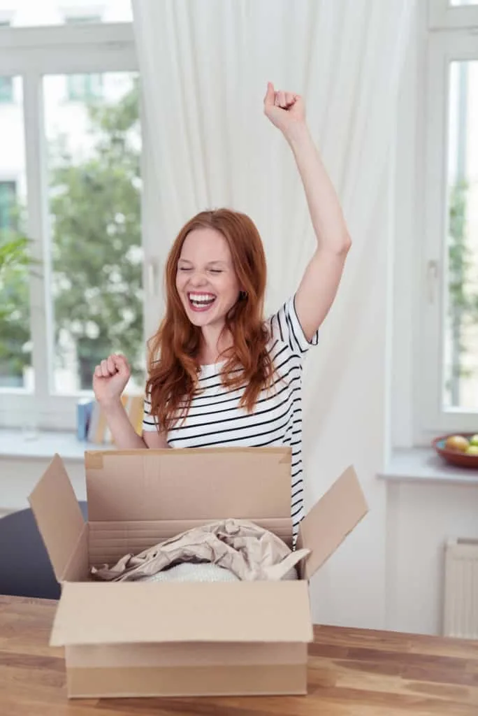 Woman opening package sent to her.