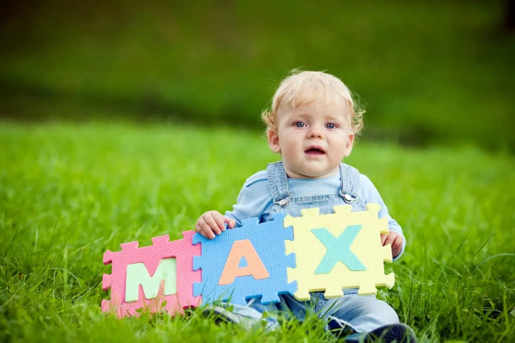 Boy holds foam letters, spelling "Max"