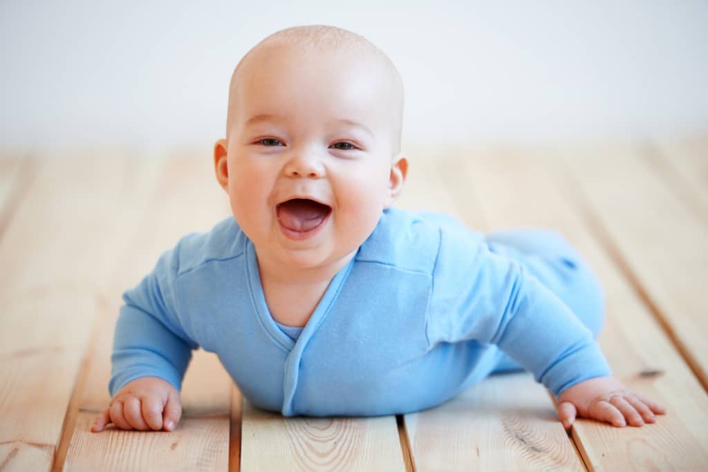 Baby boy in blue onesie.