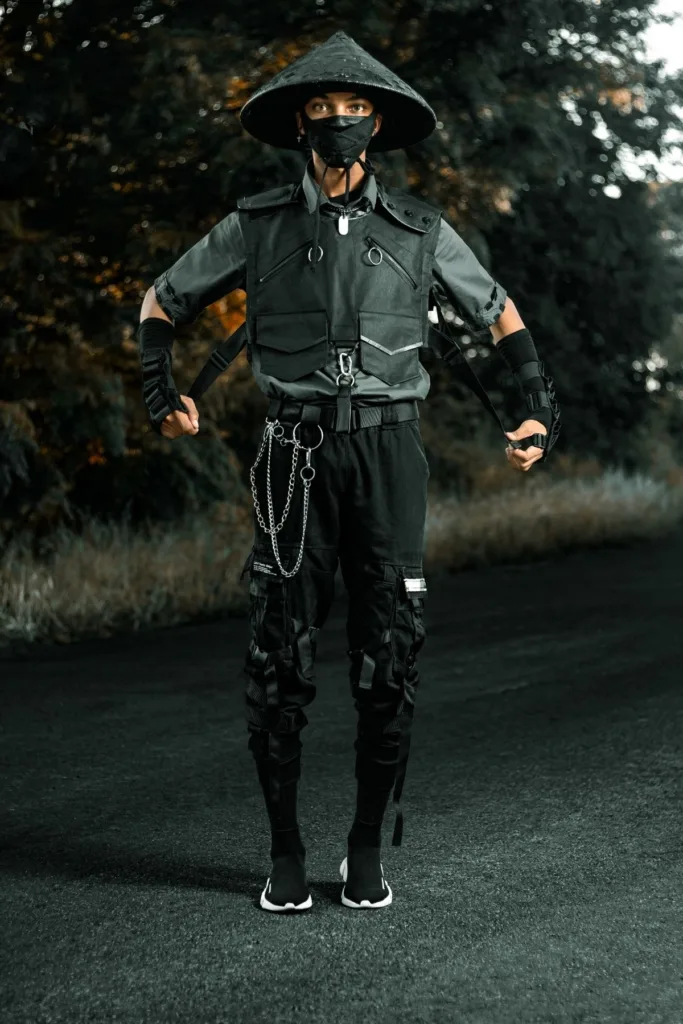 A young person dressed up as an Asian fighter outside.