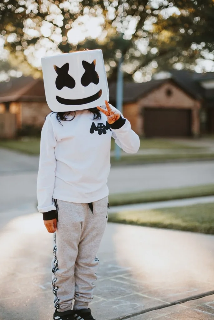 A child with a Marshmallow face mask outside.