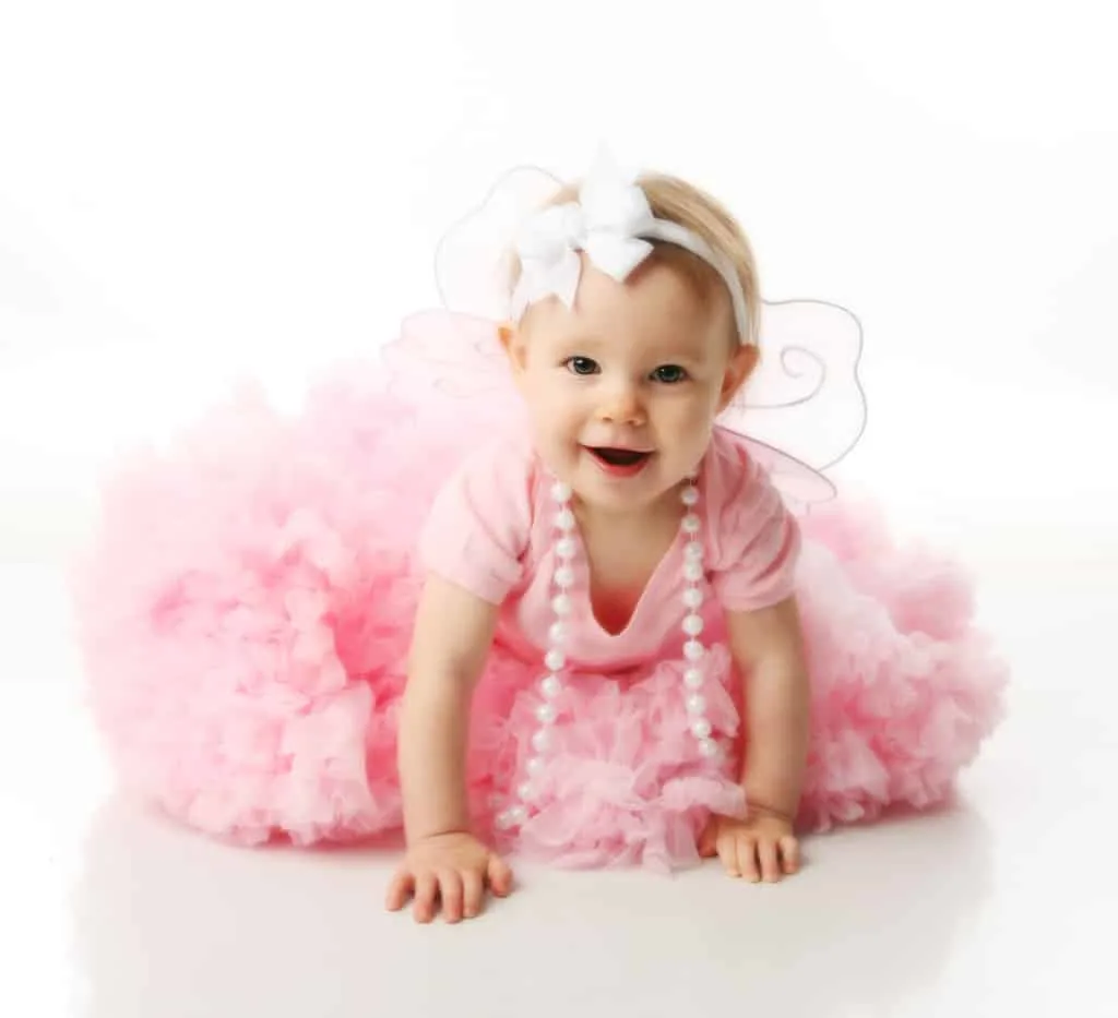 Baby in pink tutu and fairy wings.