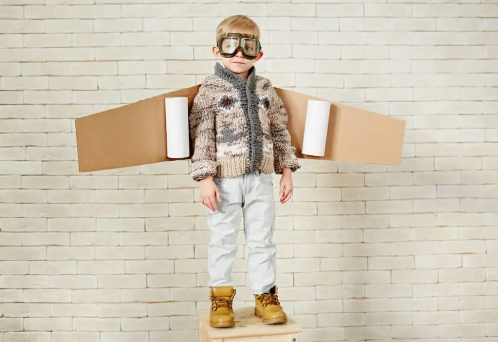 Boy wears airplane wings, one of the easiest DIY Halloween costumes for kids.
