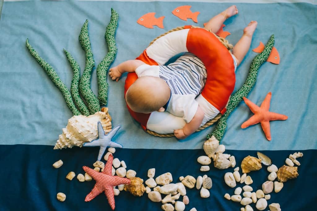 Newborn in staged ocean scenery.