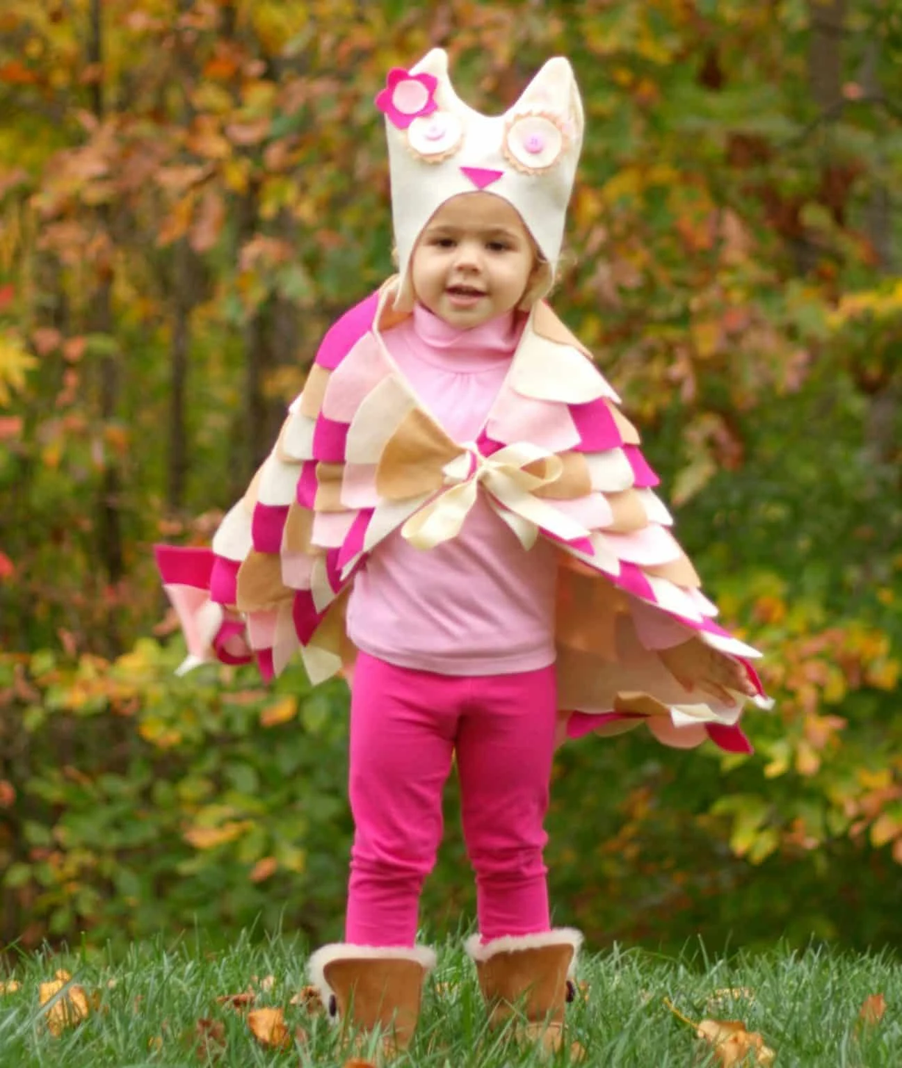 A girl in a pink, tan, and white DIY felt Owl costume.