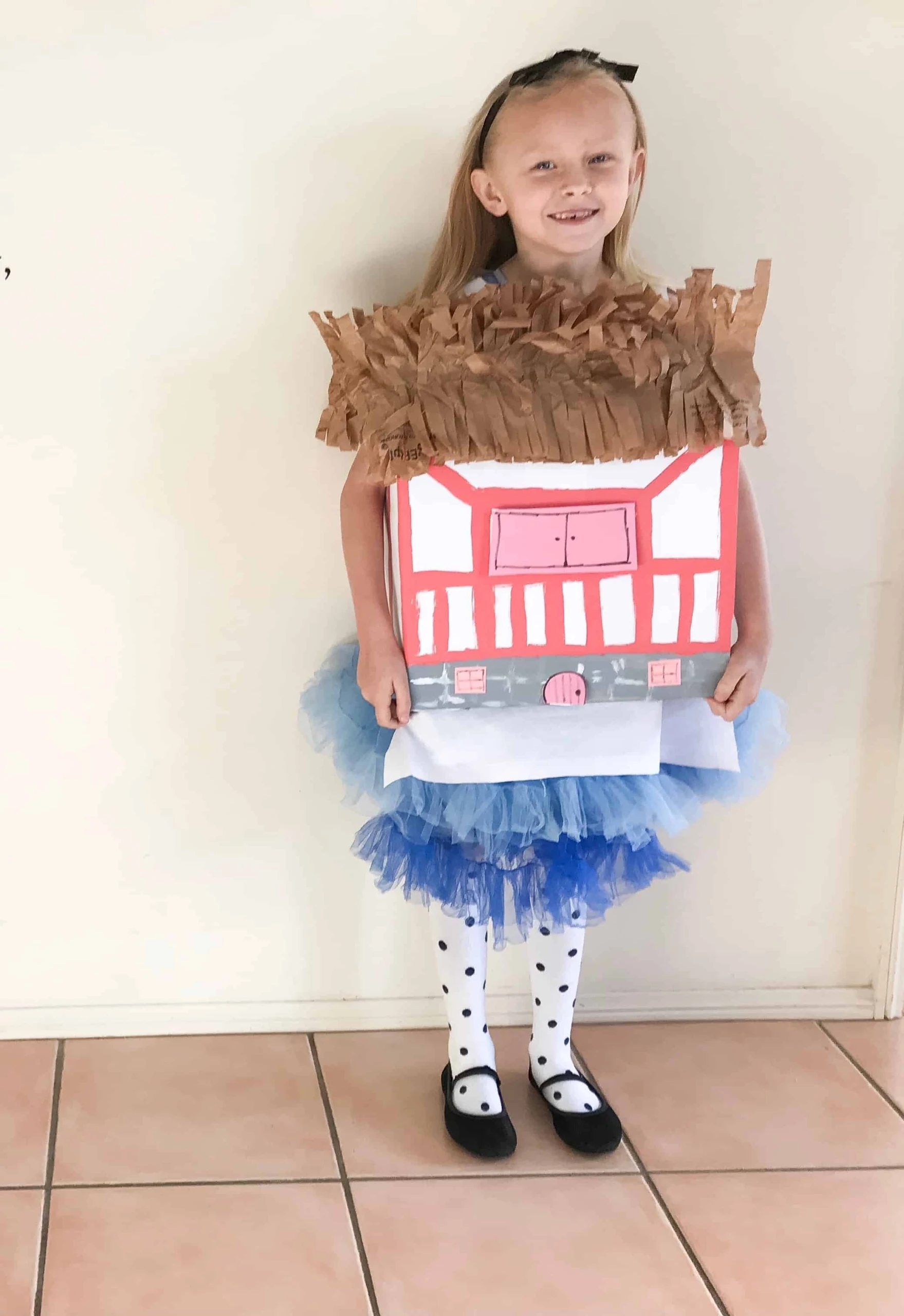 A girl in a DIY Alice in Wonderland house costume with tulle. 