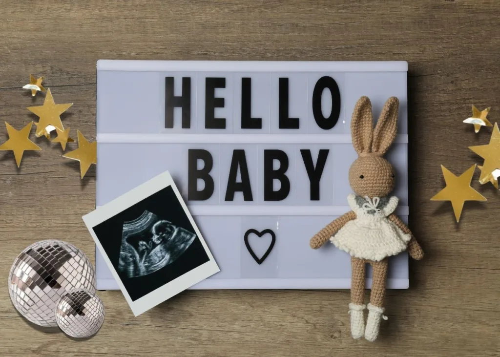 A New Year's baby announcement with a letter board, stars, and disco balls.