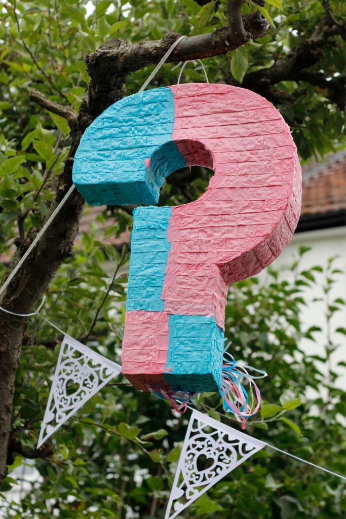 A pink and blue question mark pinata.
