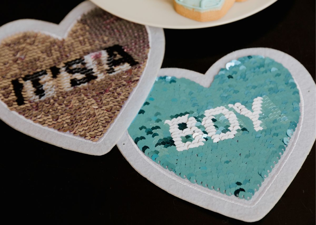 It's a boy spelled out in sequin hearts.