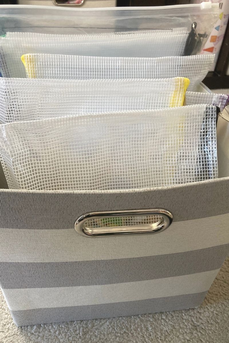 Mesh storage bags in a striped cube bin.