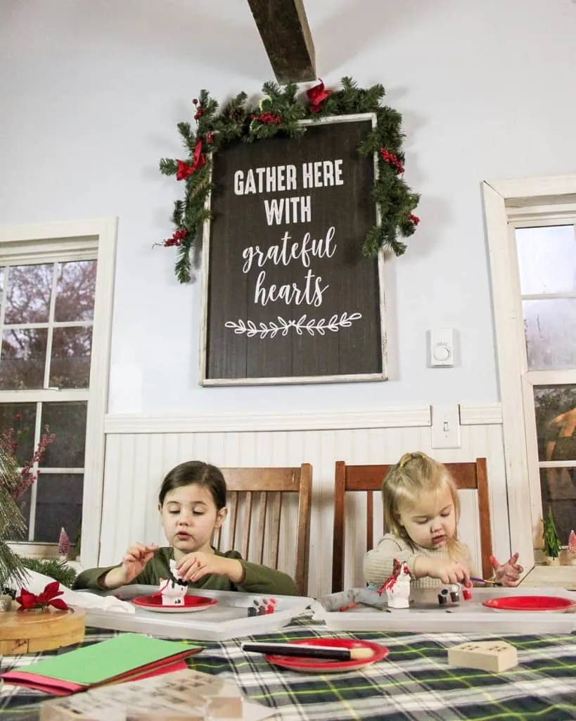 christmas decor large sign with girls crafting