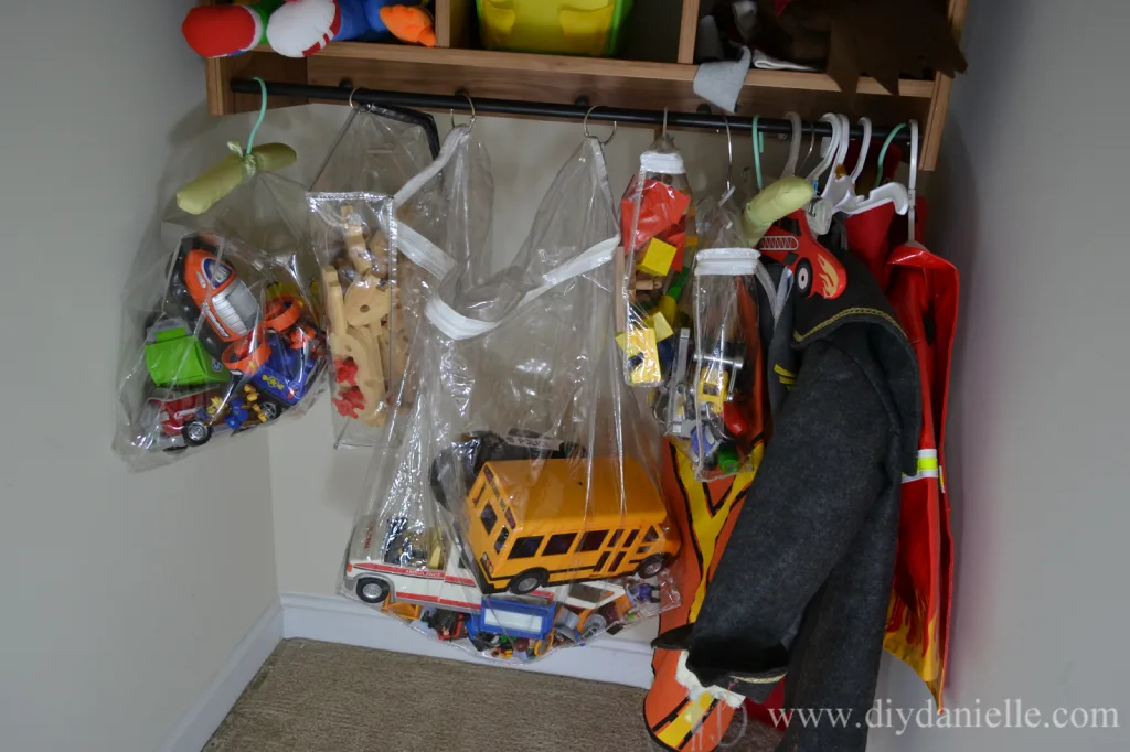 Upcycled zipper bag toy organizers hanging in a closet.