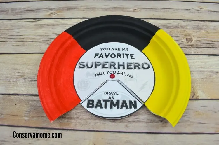 A superhero paper craft with red, black and yellow paint colors for a Father's Day gift.