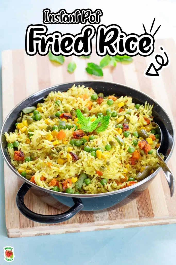 Indian fried rice in a skillet pan with veggies and cilantro garnish.