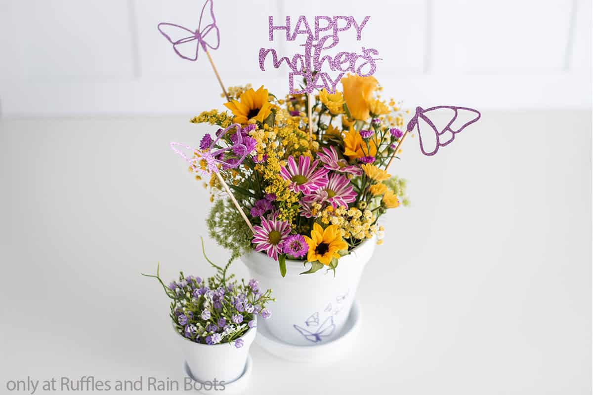 A spring flower arrangement with cricut picks for Mother's Day.
