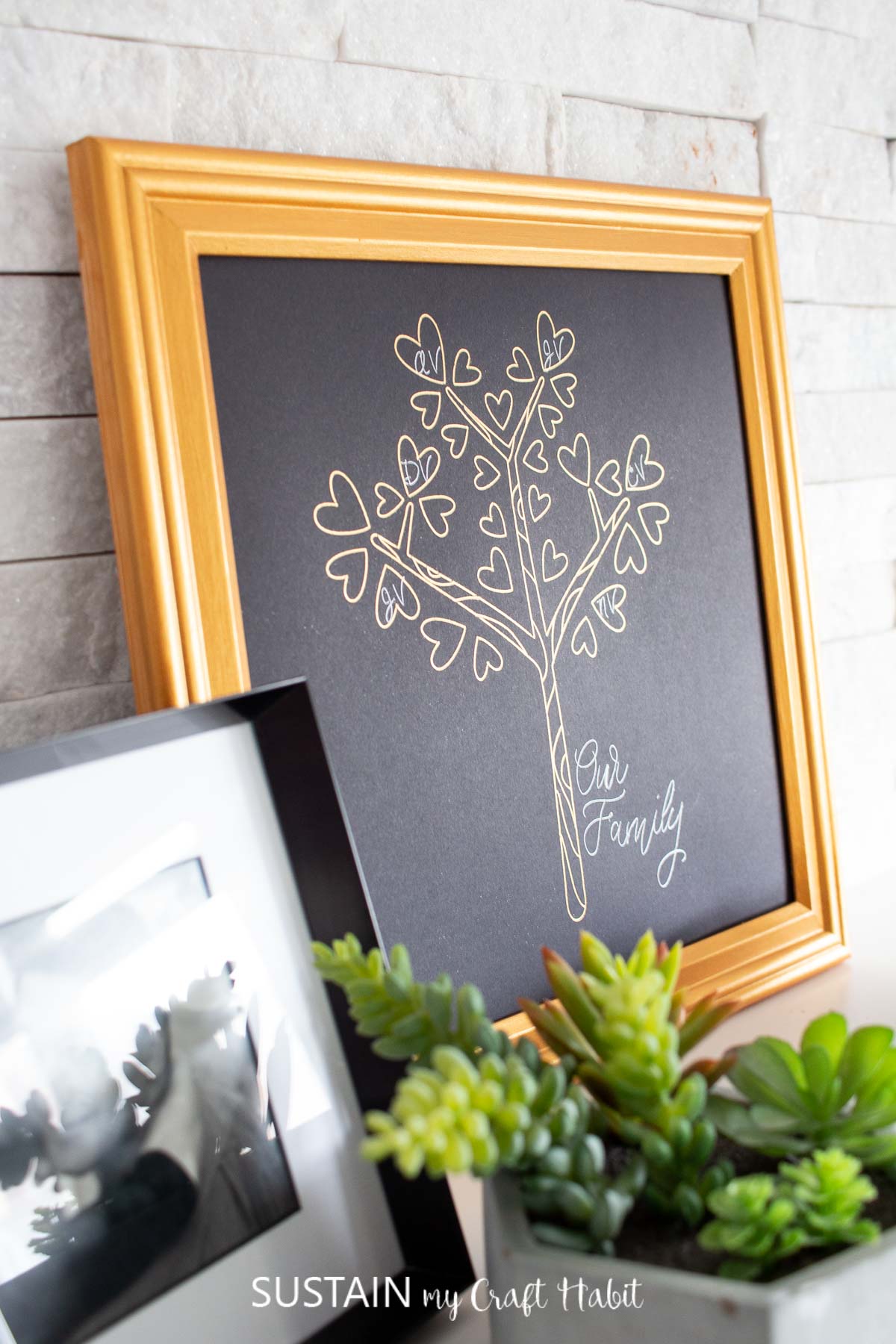 Foil transfer gold family tree in a gold frame.