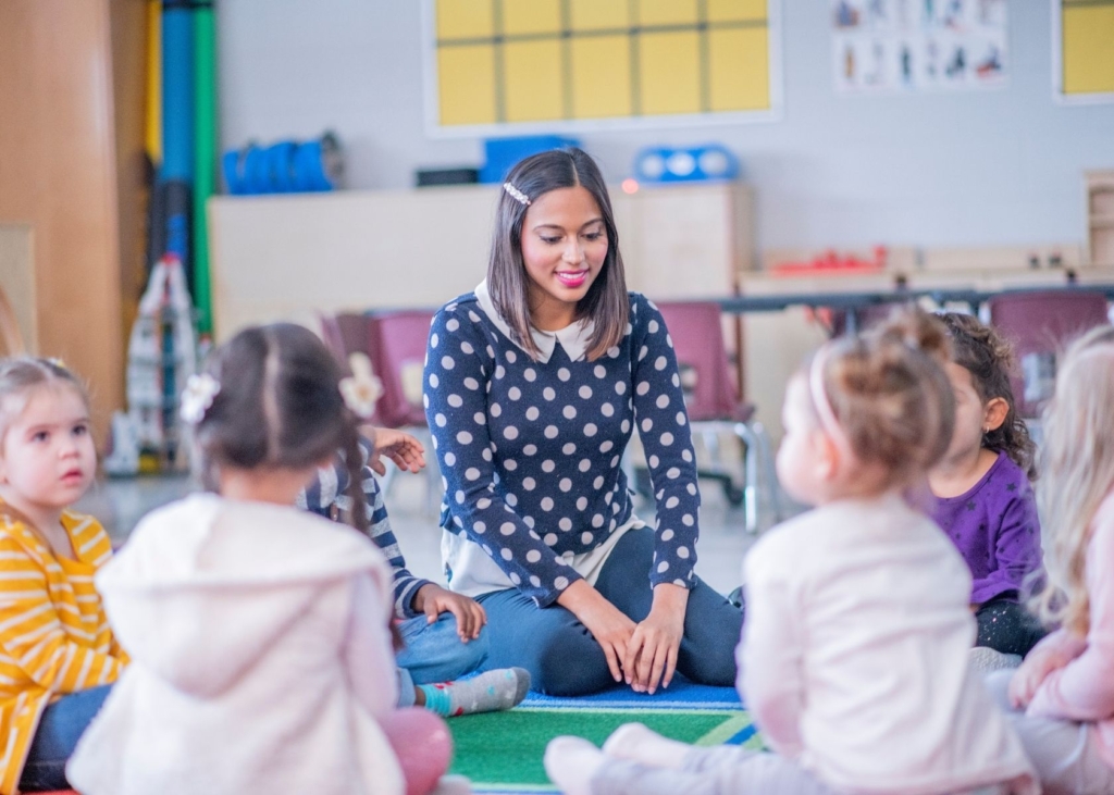 Teacher leads circle time at school.