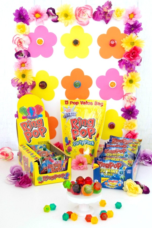 A spring-themed DIY ring toss game made with a poster board and ring pops.
