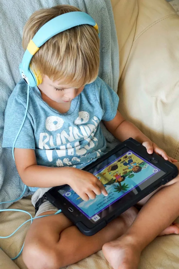 Preschooler using noggin app on a tablet.