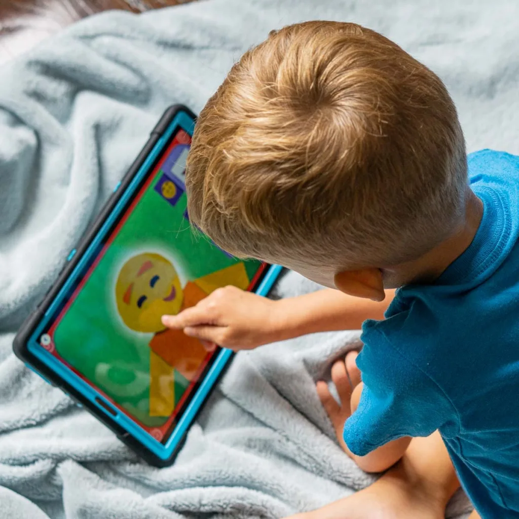 Little boy playing on a tablet.