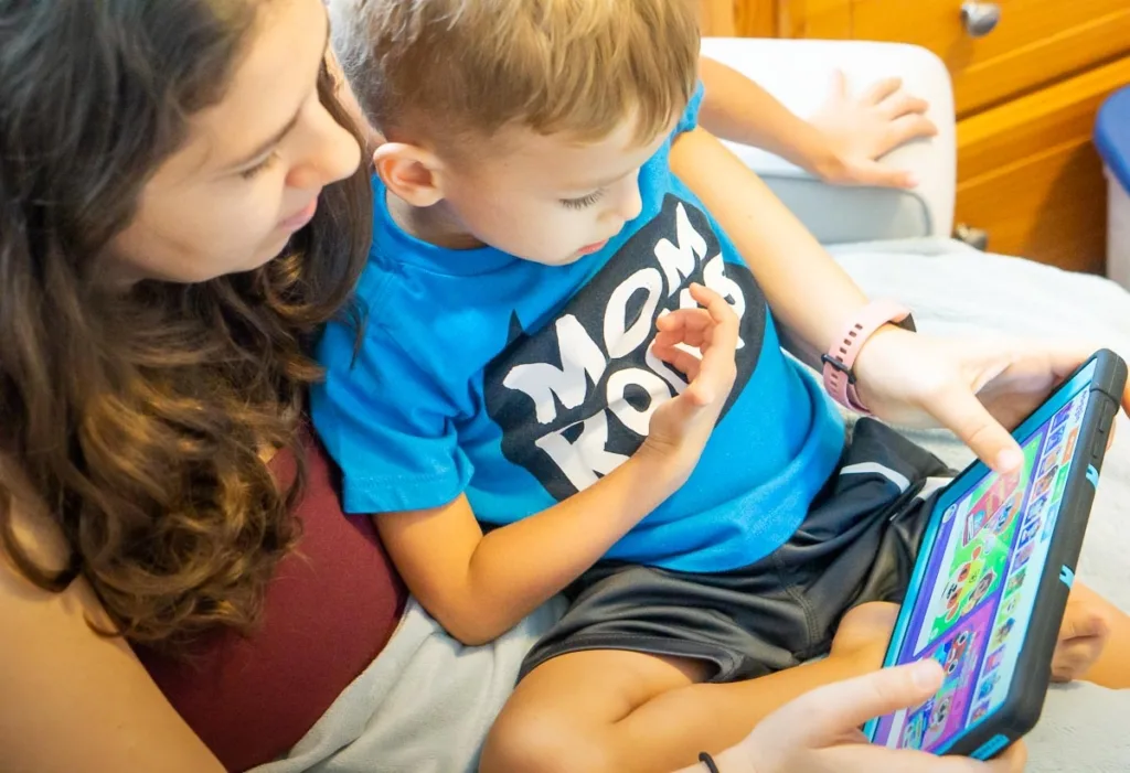 Mom and boy watching a tablet.