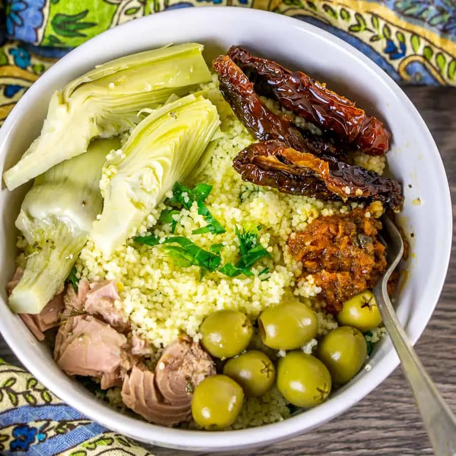 Mediterranean tuna salad with artichokes in a white bowl.