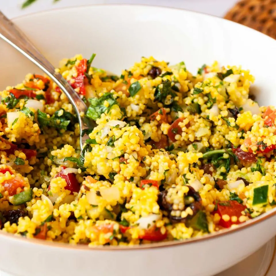 Couscous tabbouleh salad in a large white bowl.