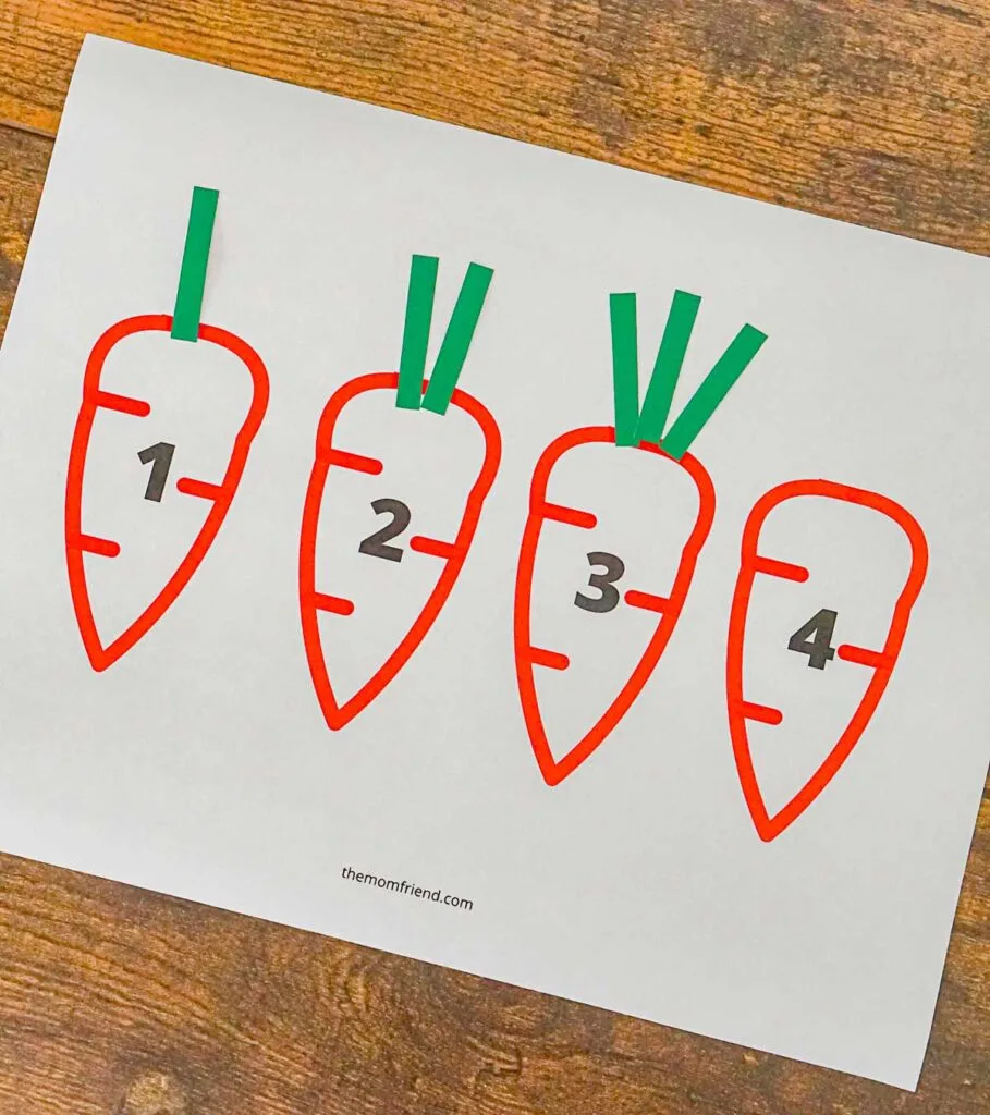 Printable counting activity where kids add the correct number of carrot tops to a picture of a carrot.