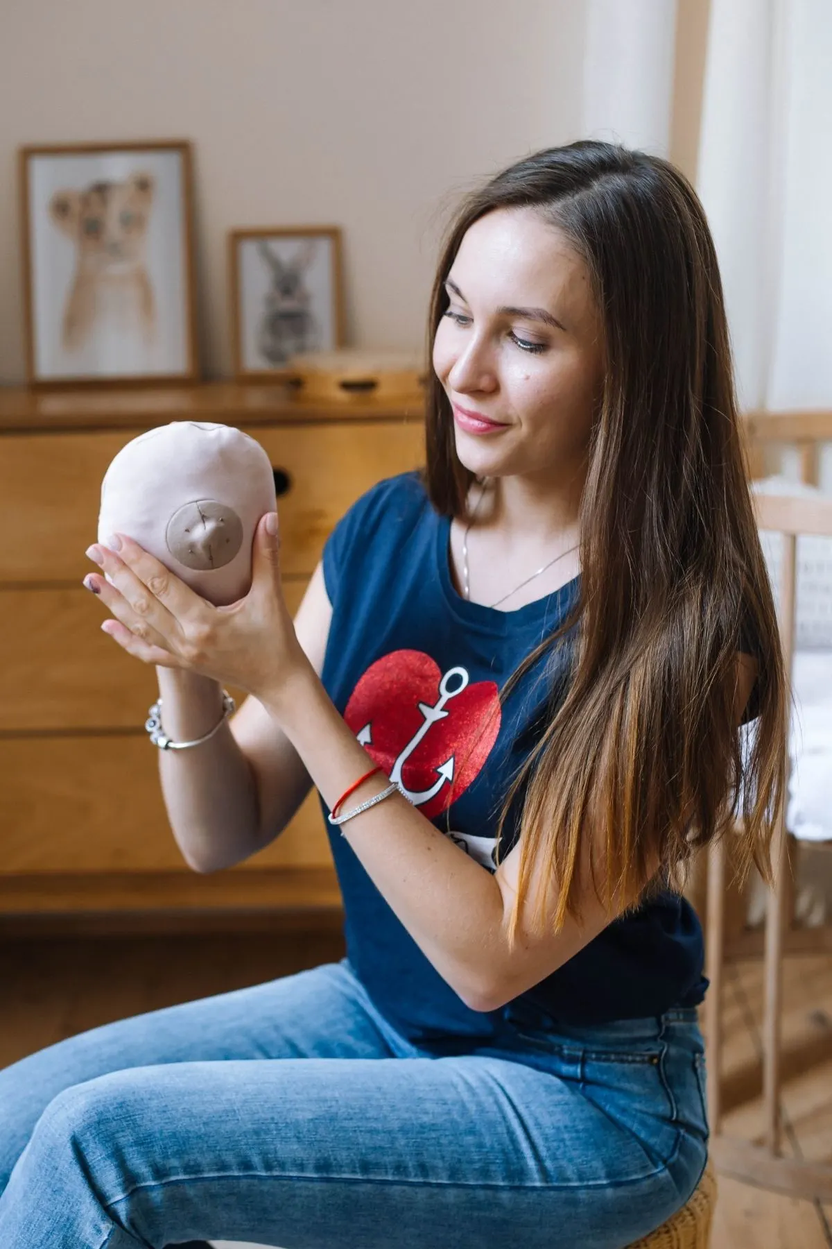 Lactation consultant holds up a breast model made out of cloth cushion.