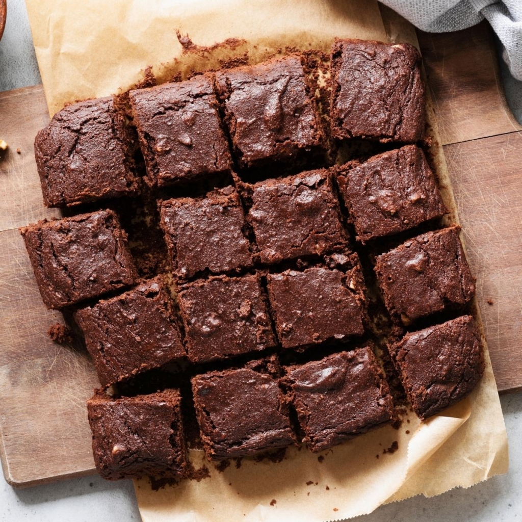 Fudgy brownies on a cutting board.