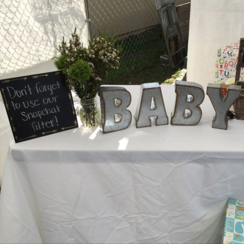 Large letters on guest book table: B, A, B, Y