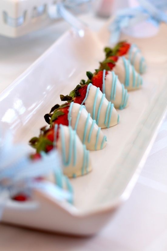 Strawberries dipped in white chocolate with blue drizzle