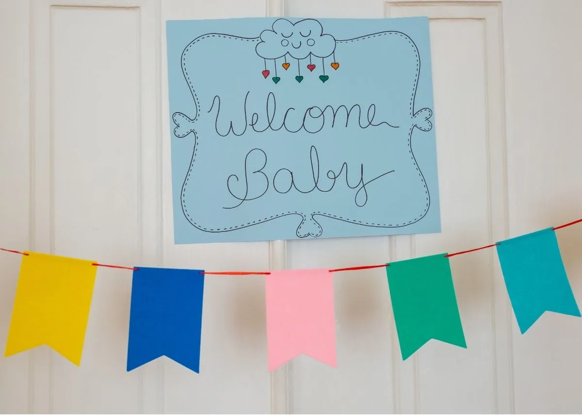 Colorful baby shower bunting banner with a sign that says "Welcome Baby".