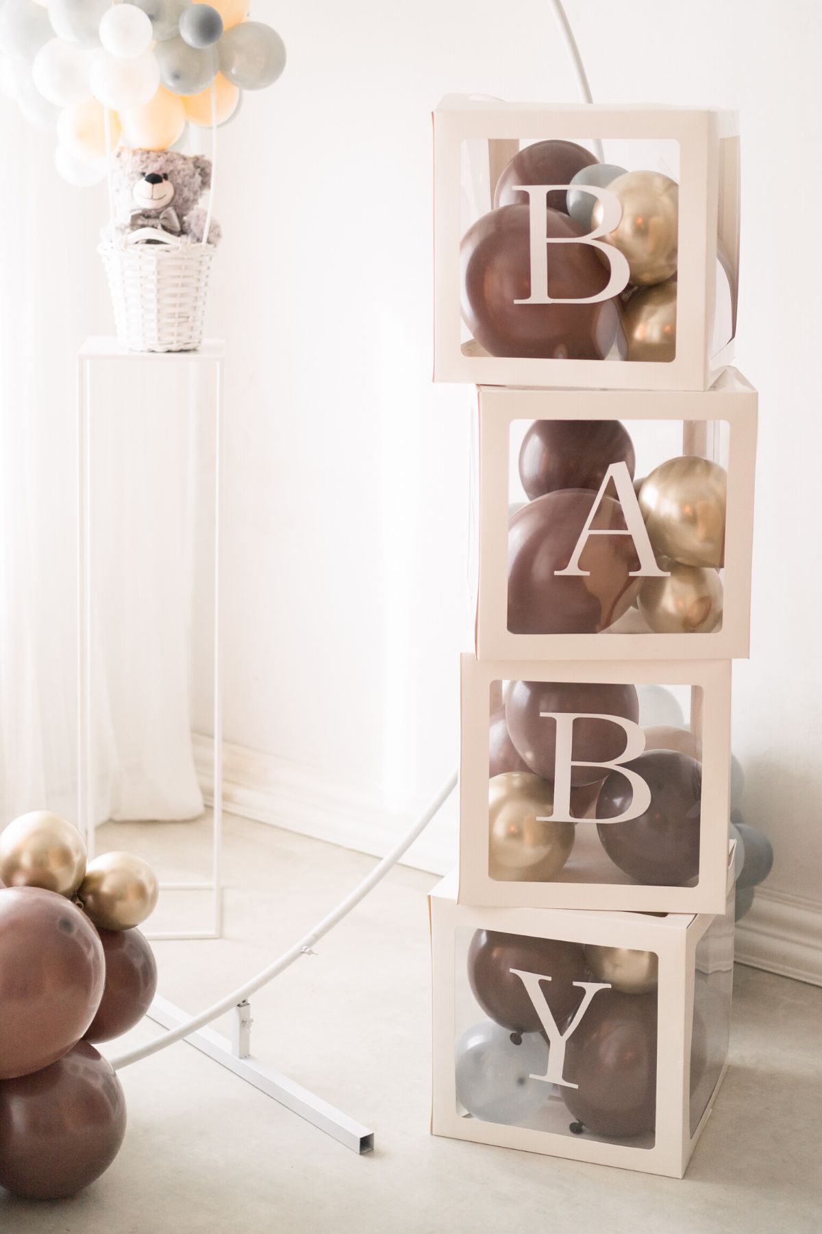 Baby balloon box blocks with brown and cream balloons inside.