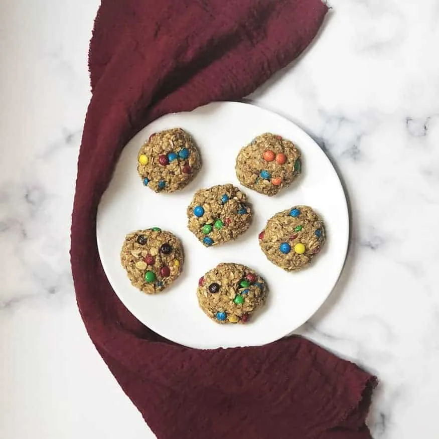 No bake lactation cookies with M&M candies on a white plate.