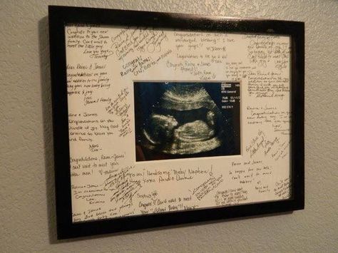 Ultrasound photo framed with baby shower guest names in the frame