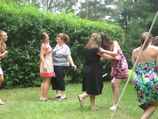 Guests at baby shower playing relay race with plunger